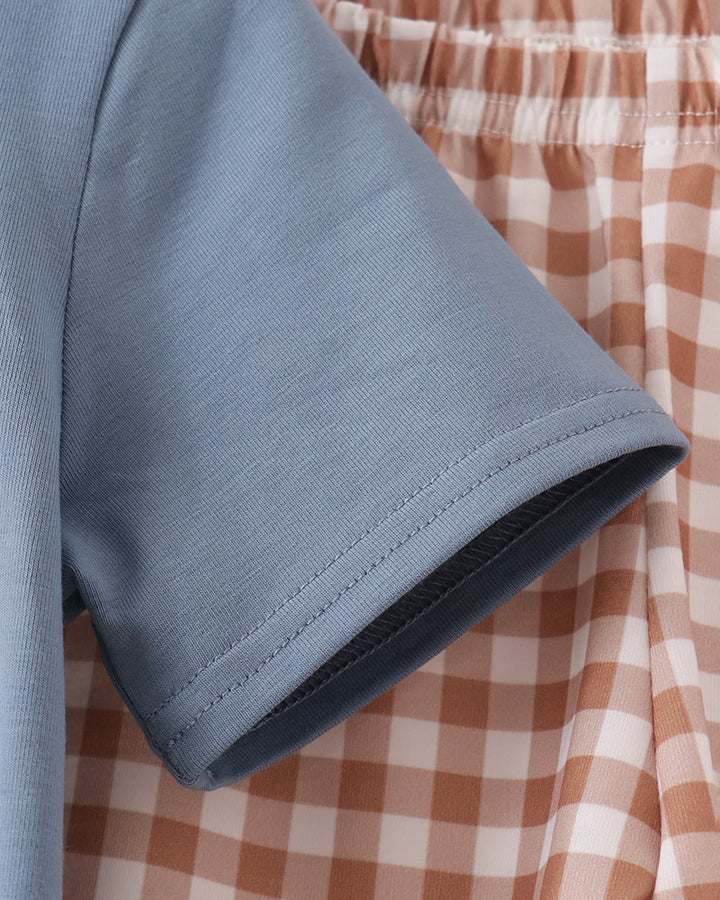 Blue shirt short sleeve cuff with orange plaid gingham pants waistband detail