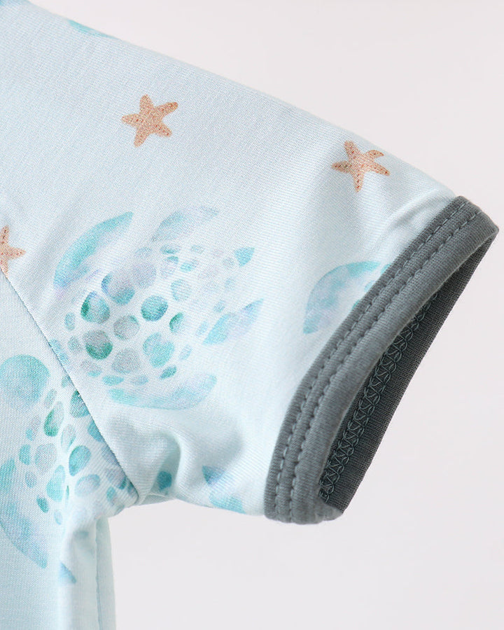 Light blue sleeveless romper with starfish and wave pattern on a white background