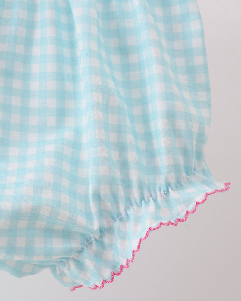 Light blue and white checkered fabric with pink trim on a light gray background