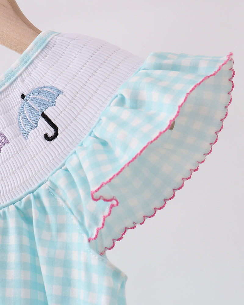 Light blue dress with ruffled hem and umbrella design on a white background