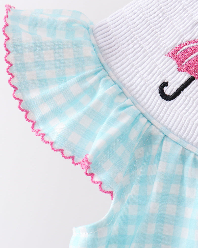 Light blue checkered dress with pink trim on a white background