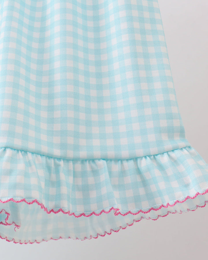 Light blue checkered dress with ruffled hem on a white background