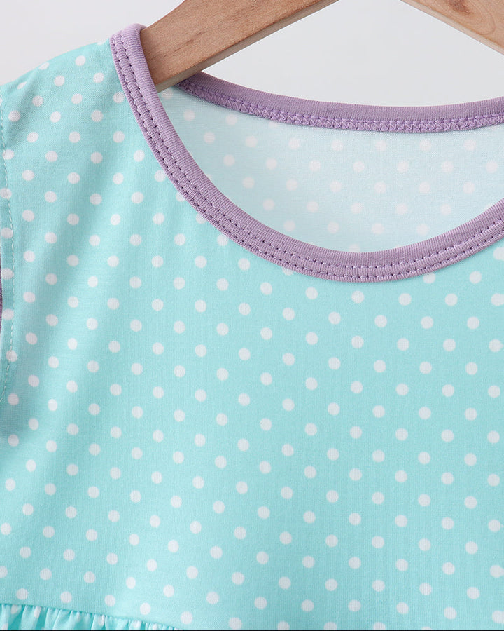 Blue polka dot dress on hanger