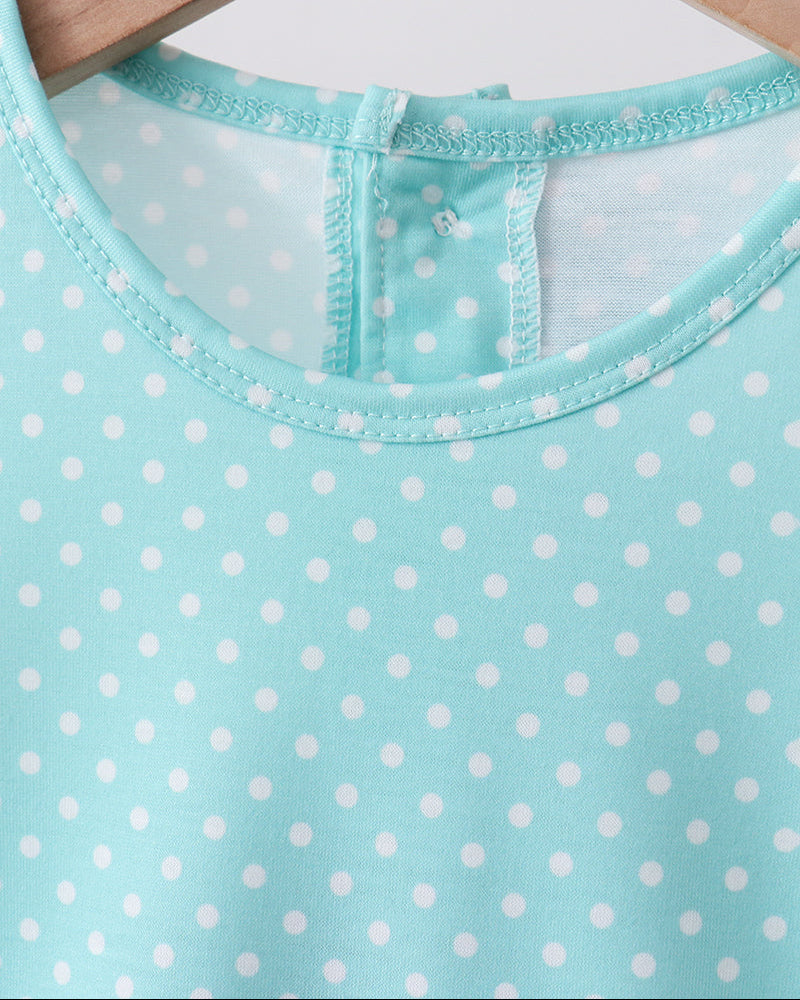 Blue polka dot dress on hanger