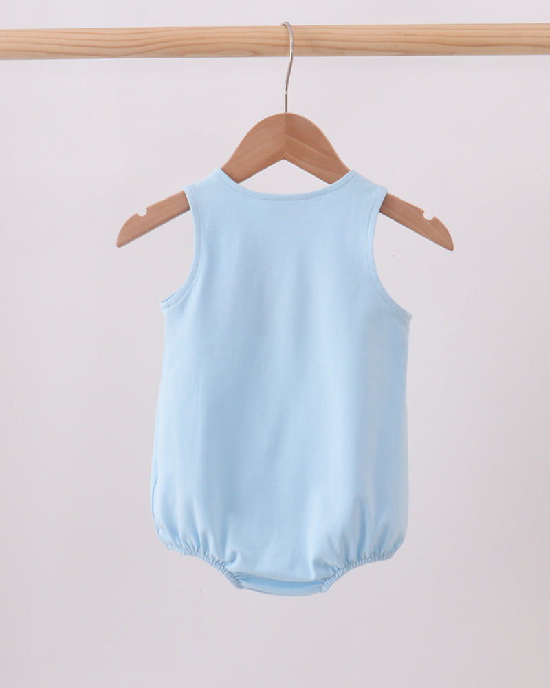 A light blue sleeveless baby bodysuit or romper hanging from a wooden hanger on a wooden clothes rack against a plain light background.
