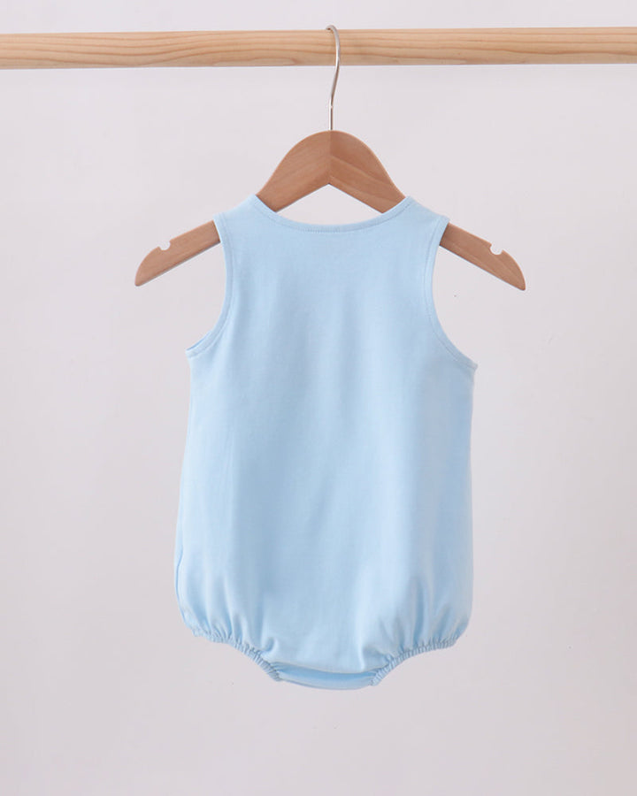 A light blue sleeveless baby bodysuit or romper hanging from a wooden hanger on a wooden clothes rack against a plain light background.