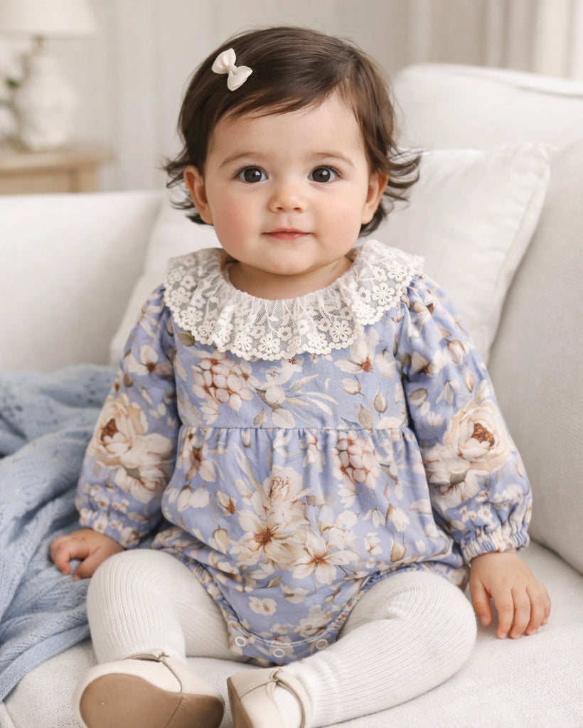 Floral baby bodysuit with lace collar, long sleeves, and blue floral print