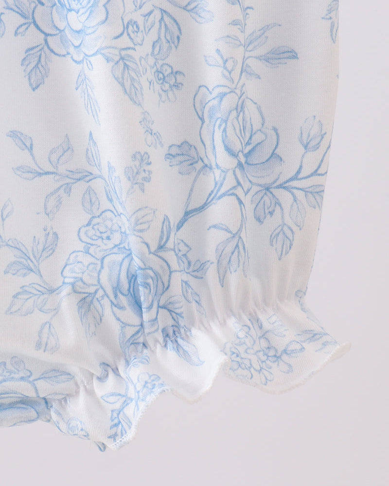 White fabric with blue floral pattern on a white background