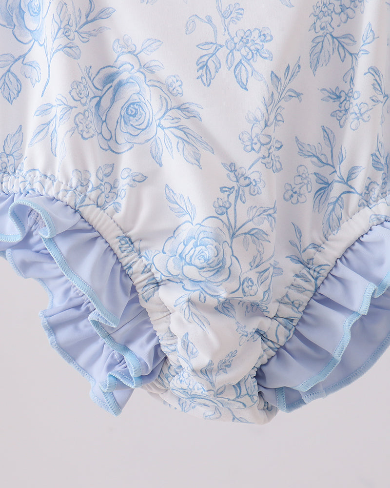 Floral rashguard with ruffles on a light gray background