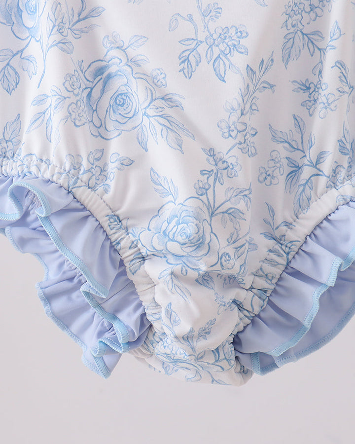 Floral rashguard with ruffles on a light gray background