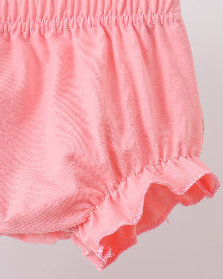 Pink baby bloomers on a light gray background