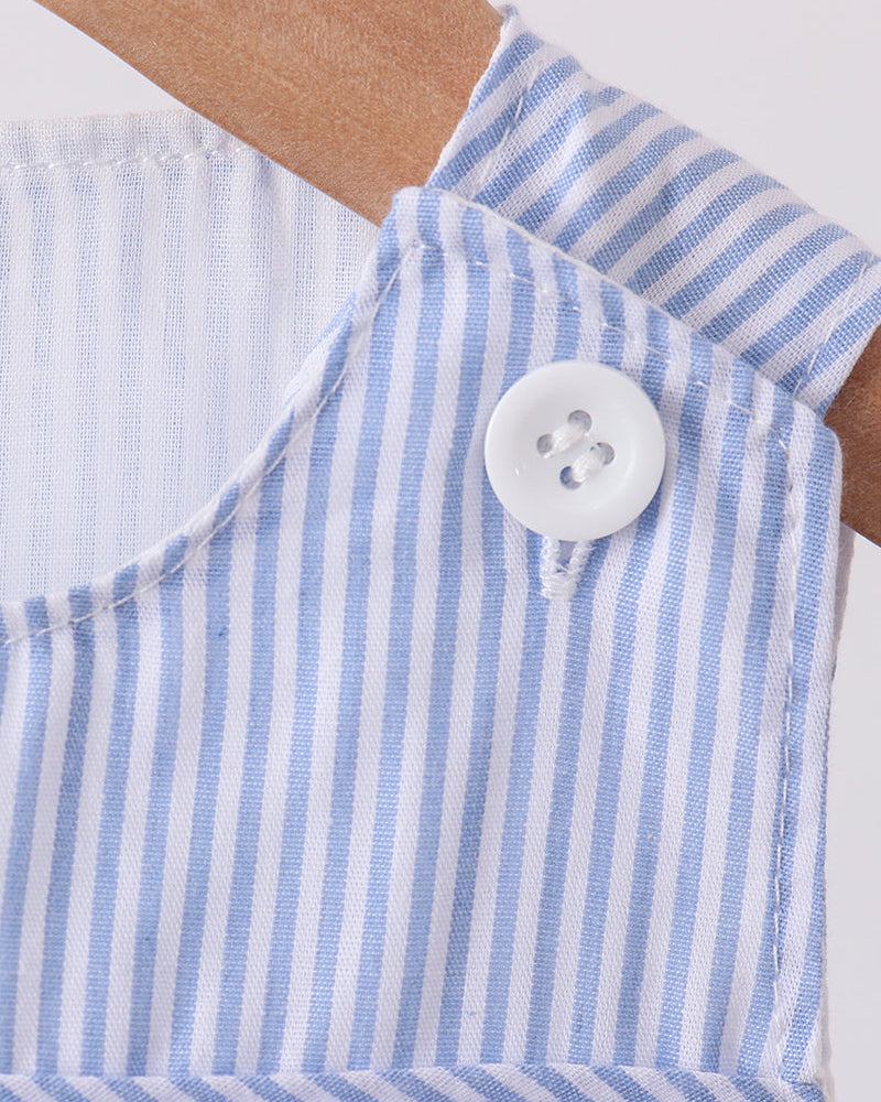 Close-up of a blue and white striped fabric with a button, on a white background.