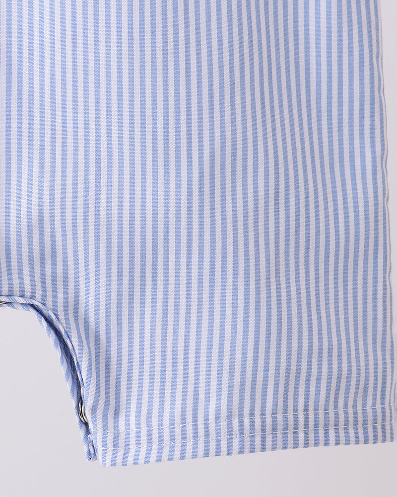 Close-up of a blue and white striped fabric with a plain background