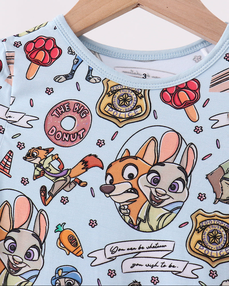 Light blue pajama top with cartoon character print and crew neckline