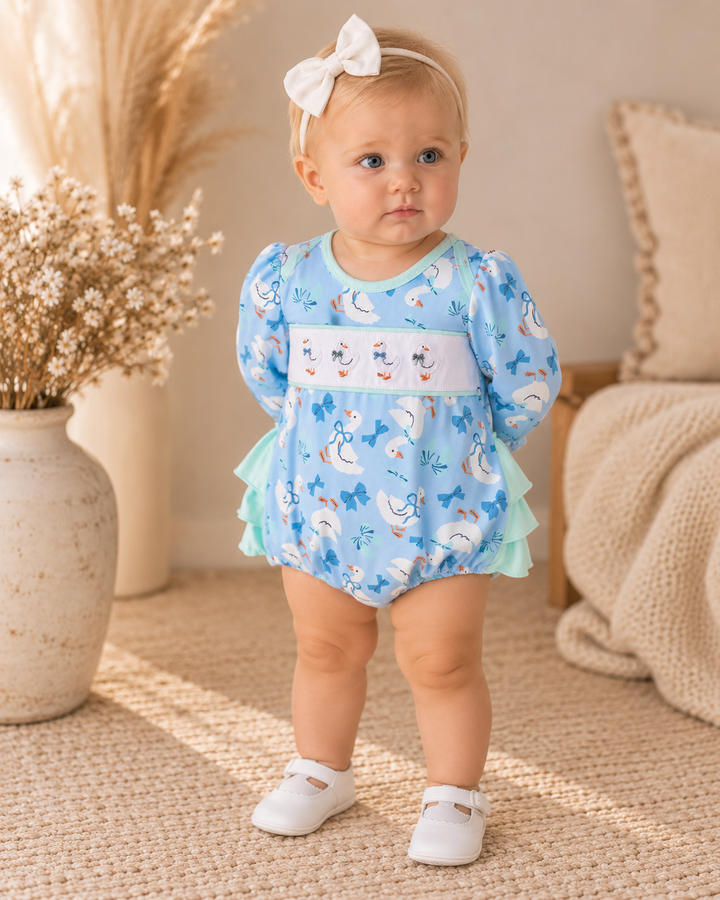 Light blue goose print ruffle bubble romper on child with mint layered ruffles