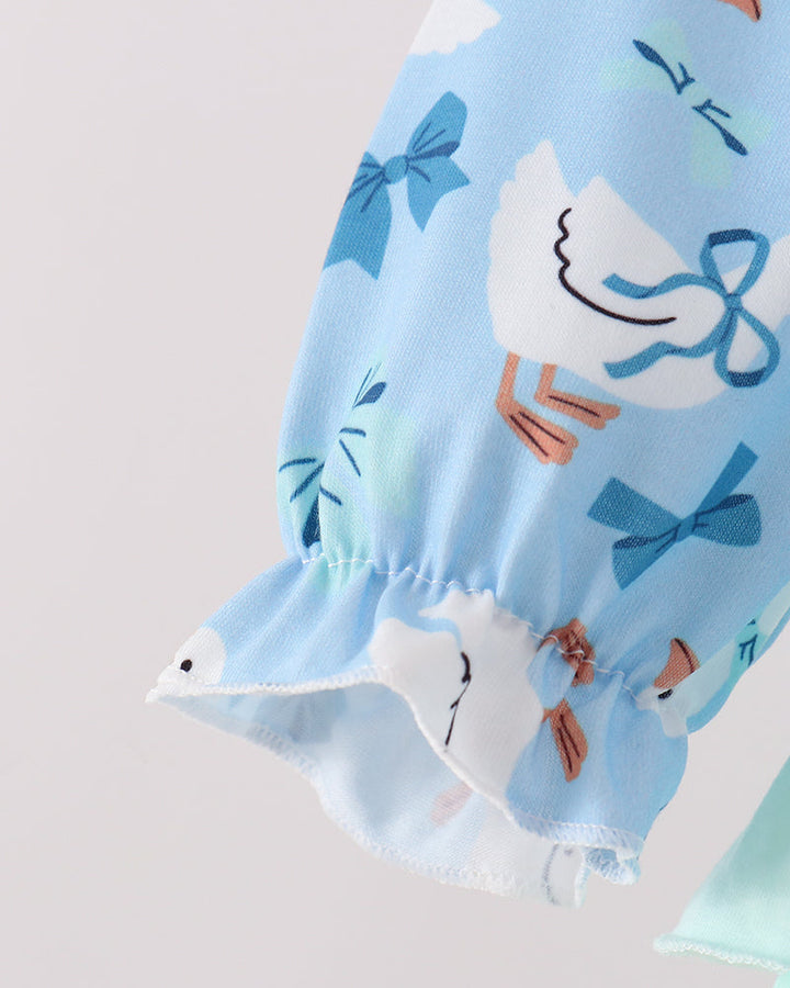 Light blue printed bubble romper sleeve cuff with layered white ruffle hem