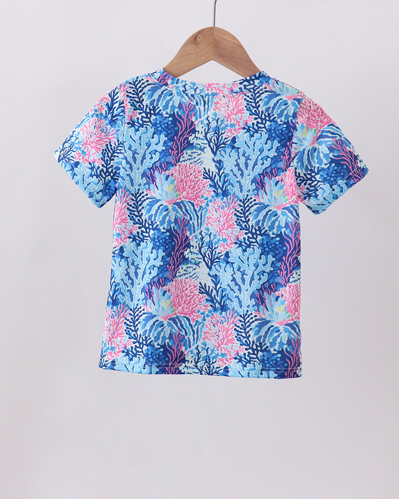 Blue floral patterned shirt on a hanger against a white background