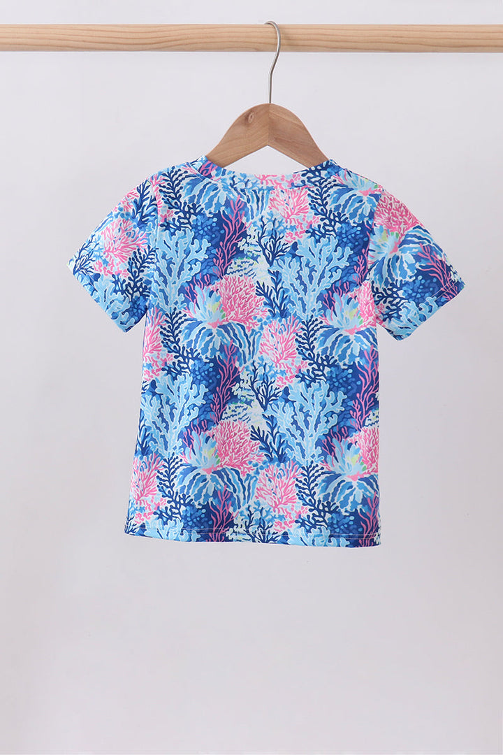 Blue floral patterned shirt on a hanger against a white background