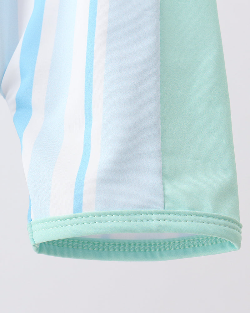 Close-up of a light blue and green striped fabric on a white background