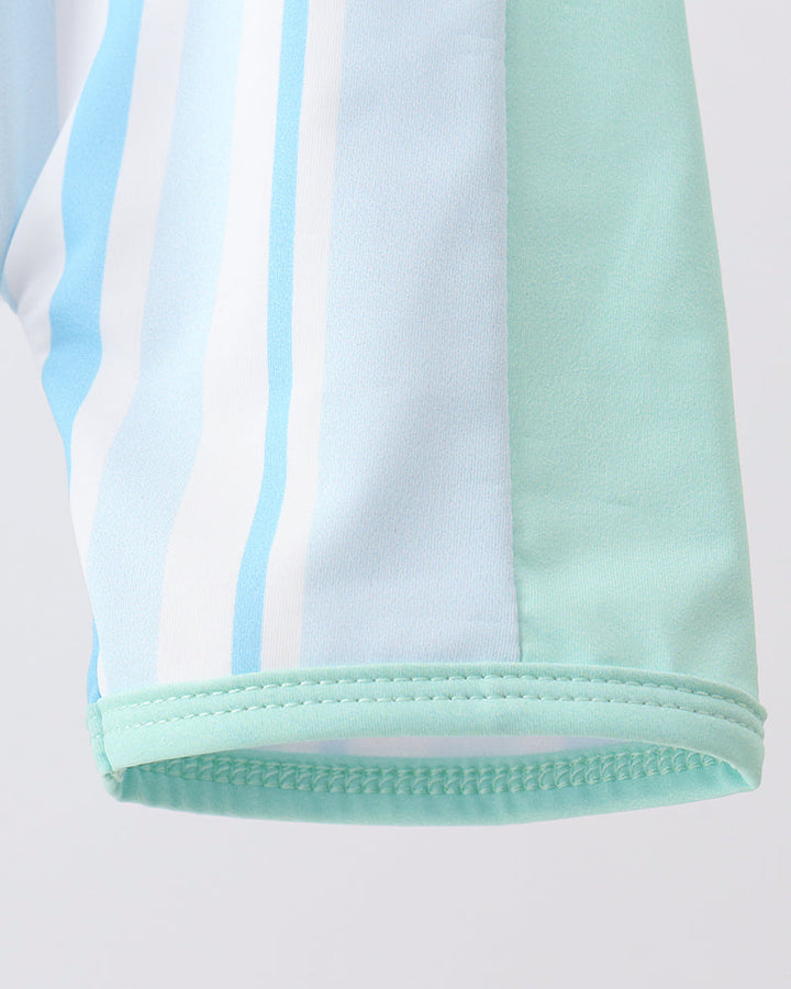 Close-up of a light blue and green striped fabric on a white background