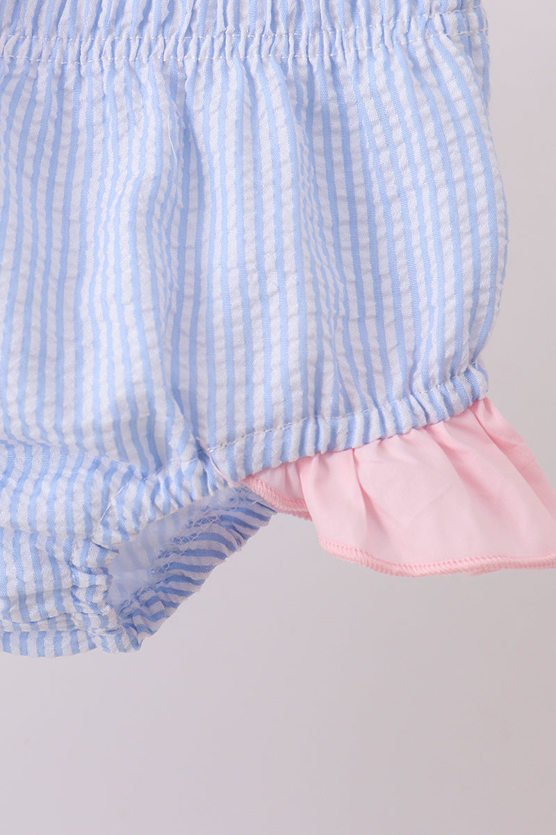 Close-up of blue and pink checkered shorts with a plain background