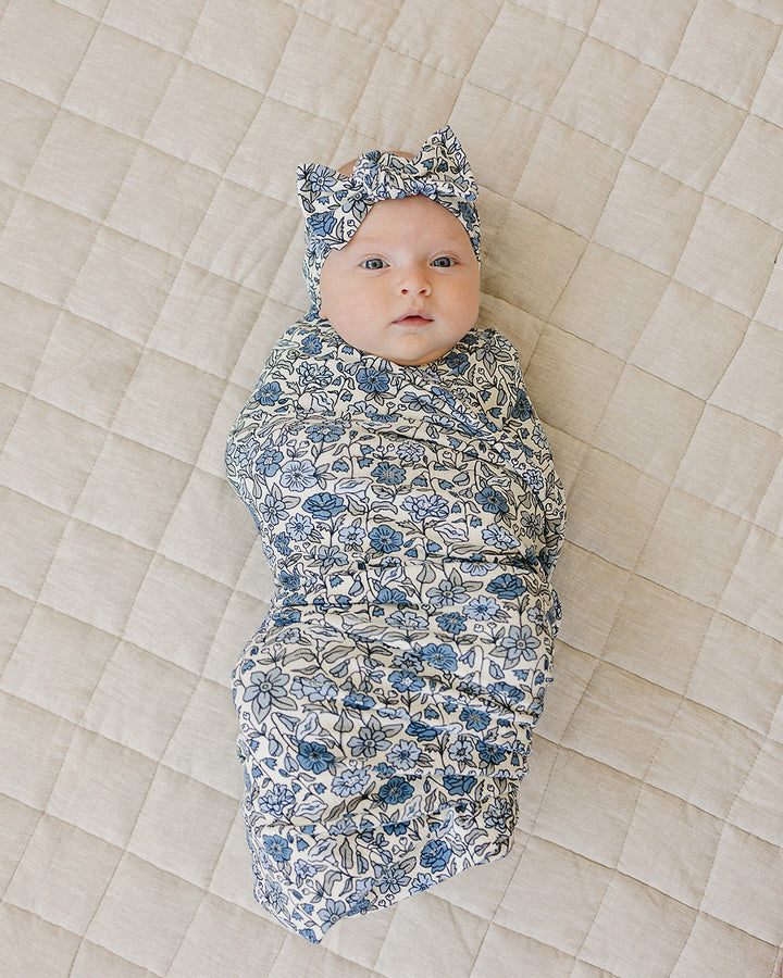 Baby head wrap with blue-and-white floral print and top knot bow