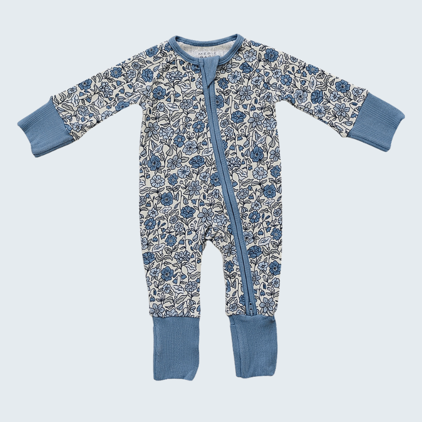 Baby onesie with floral pattern and blue accents on a light gray background