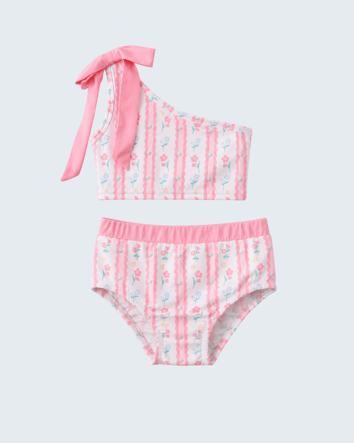 Two-piece swimsuit with pink and floral design on a light gray background