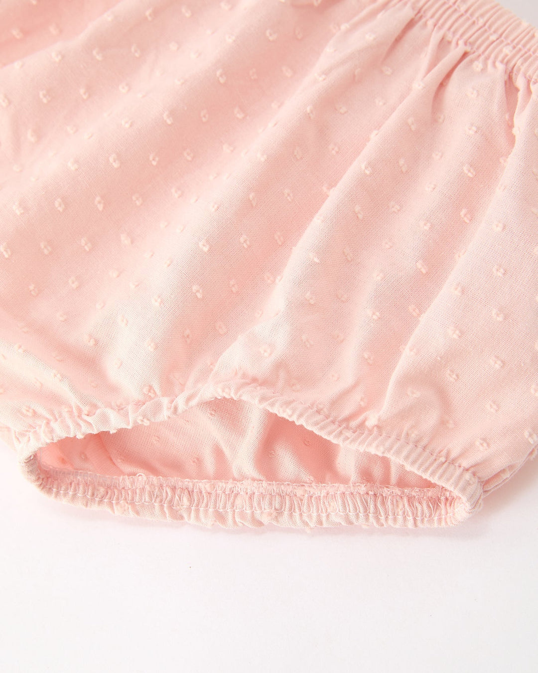 Pink bloomer shorts with elastic waistband and ruffled leg hem