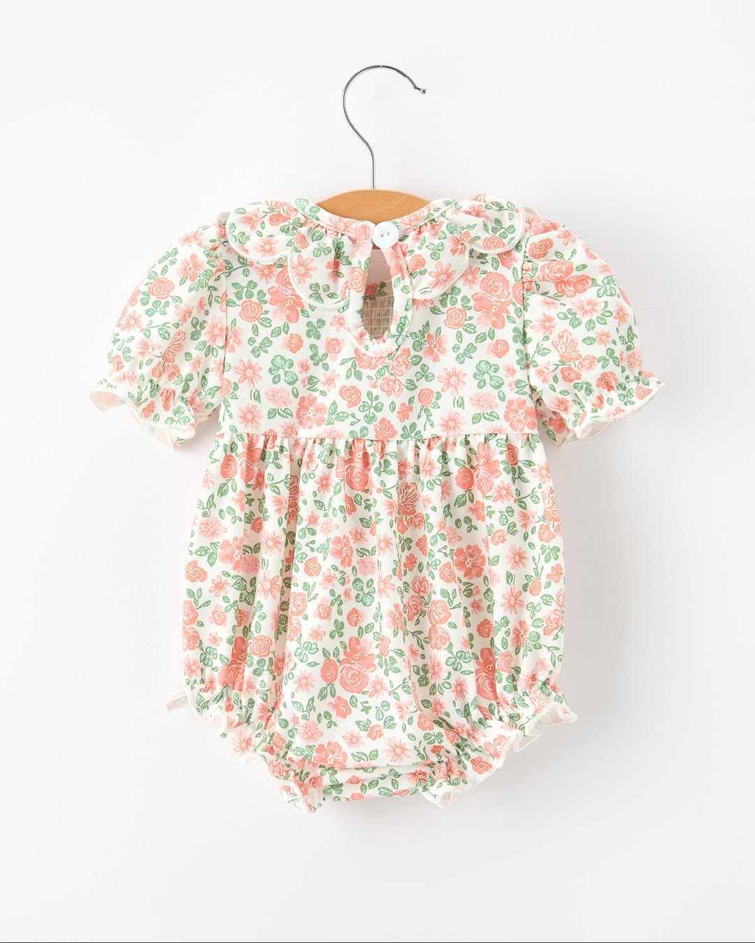 Pastel floral short-sleeve baby romper with ruffled petal neckline and gathered waist