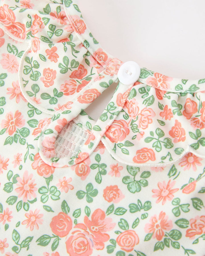 Petal collar with button on floral girls dress, peach roses and green leaves