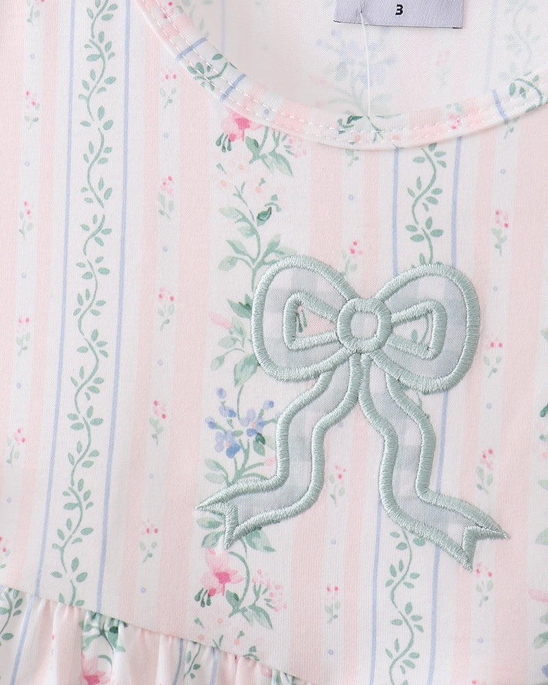 Dress with a large bow and floral patterns on a striped background