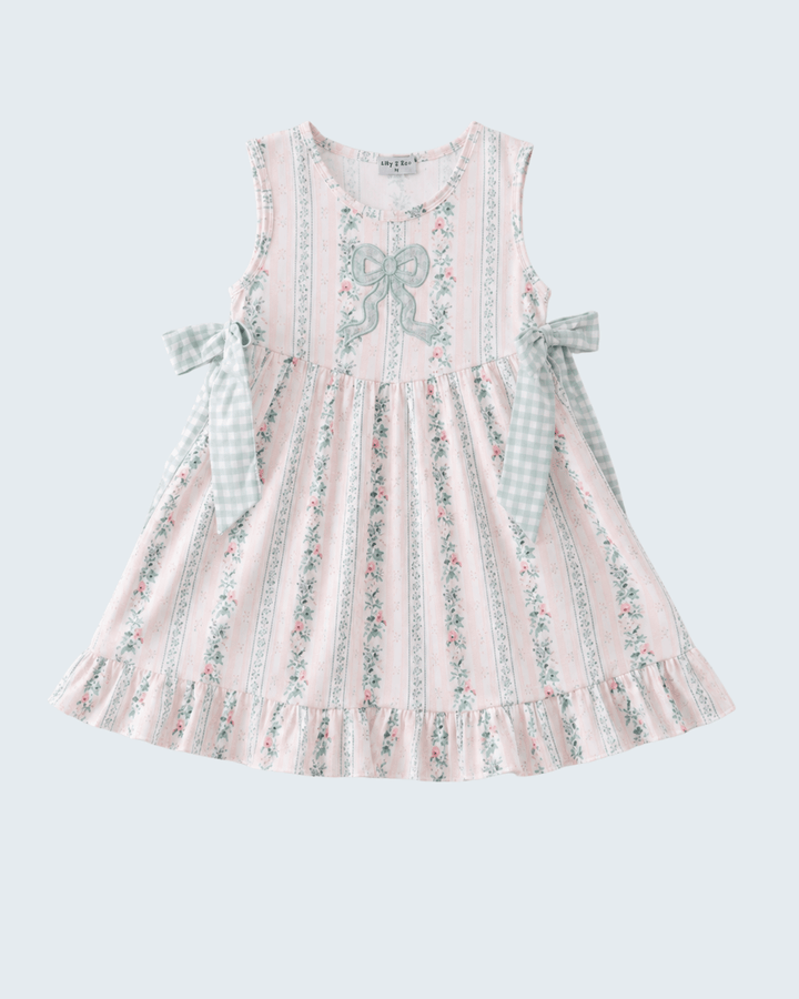 Pink floral dress with bow details on a light gray background