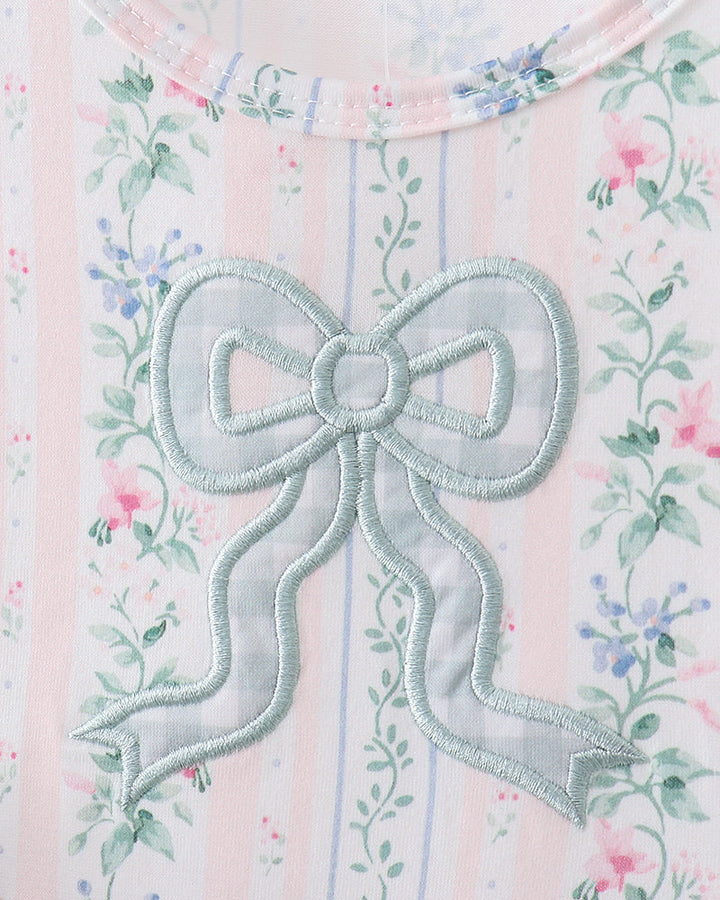 Embroidered bow on a floral dress with a white background