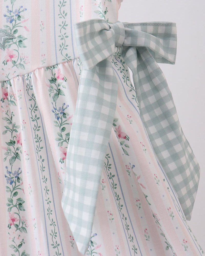 Dress with floral and gingham patterns on a white background