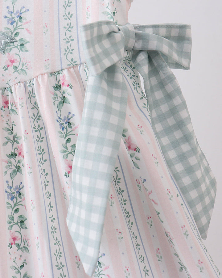 Dress with floral and gingham patterns on a white background