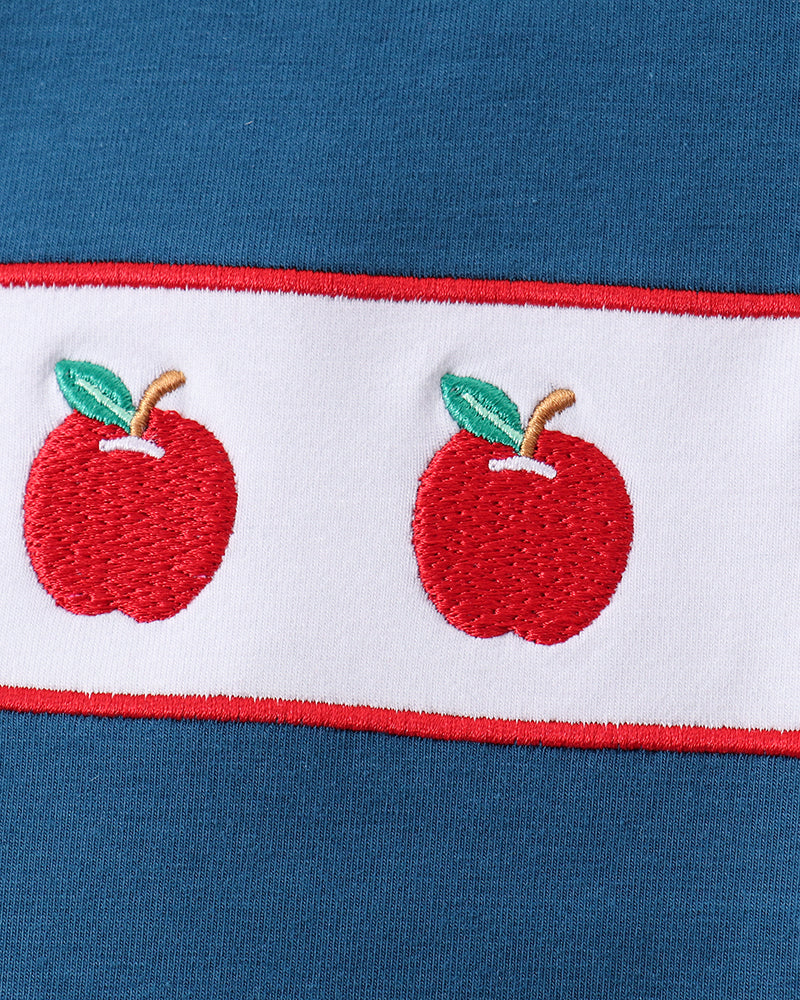 Blue fabric with embroidery apples