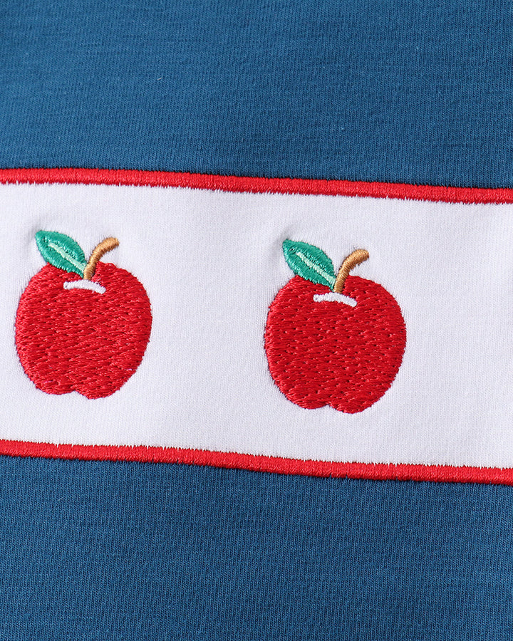 Blue fabric with embroidery apples