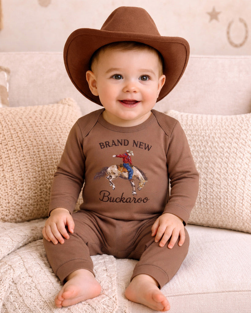 Baby wearing a brown cowboy hat and &