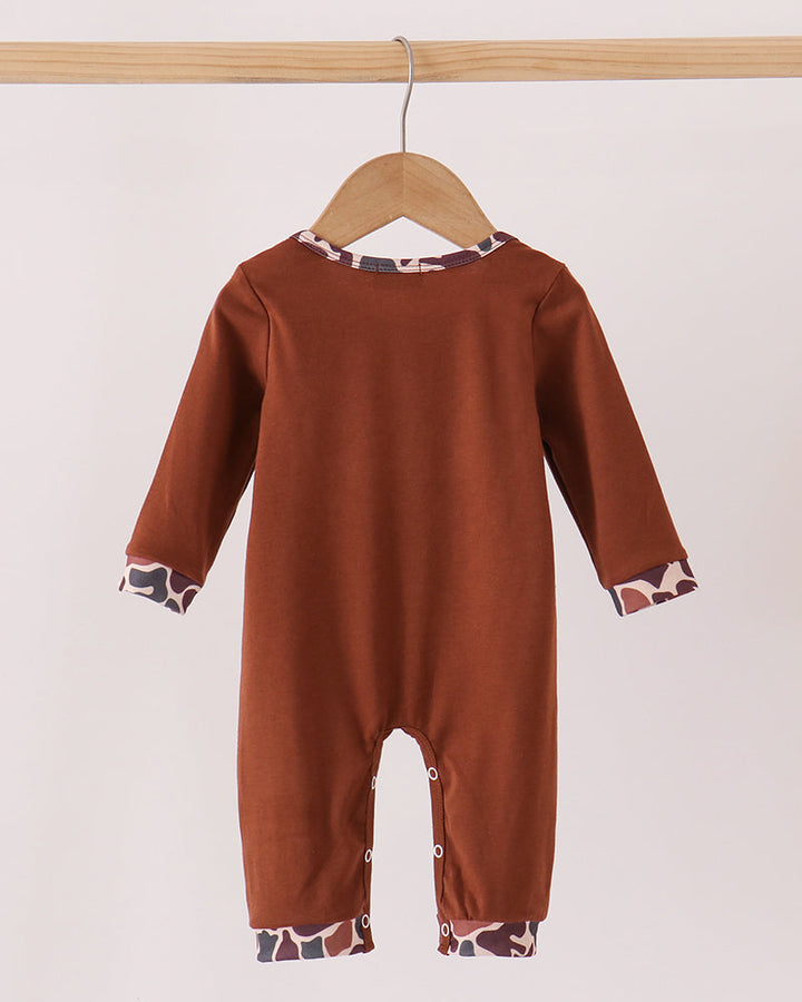 Brown romper with buttoned crotch and camo trim cuffs on sleeves