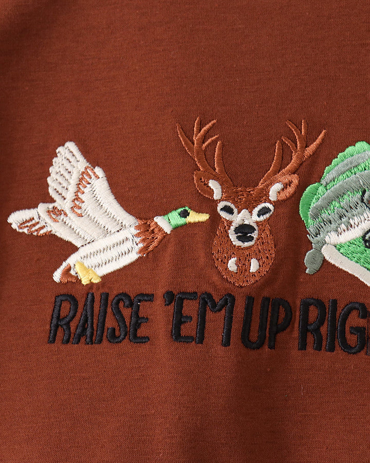 Brown long-sleeve shirt with reindeer applique and “RAISE EM UP RIGHT” embroidery.