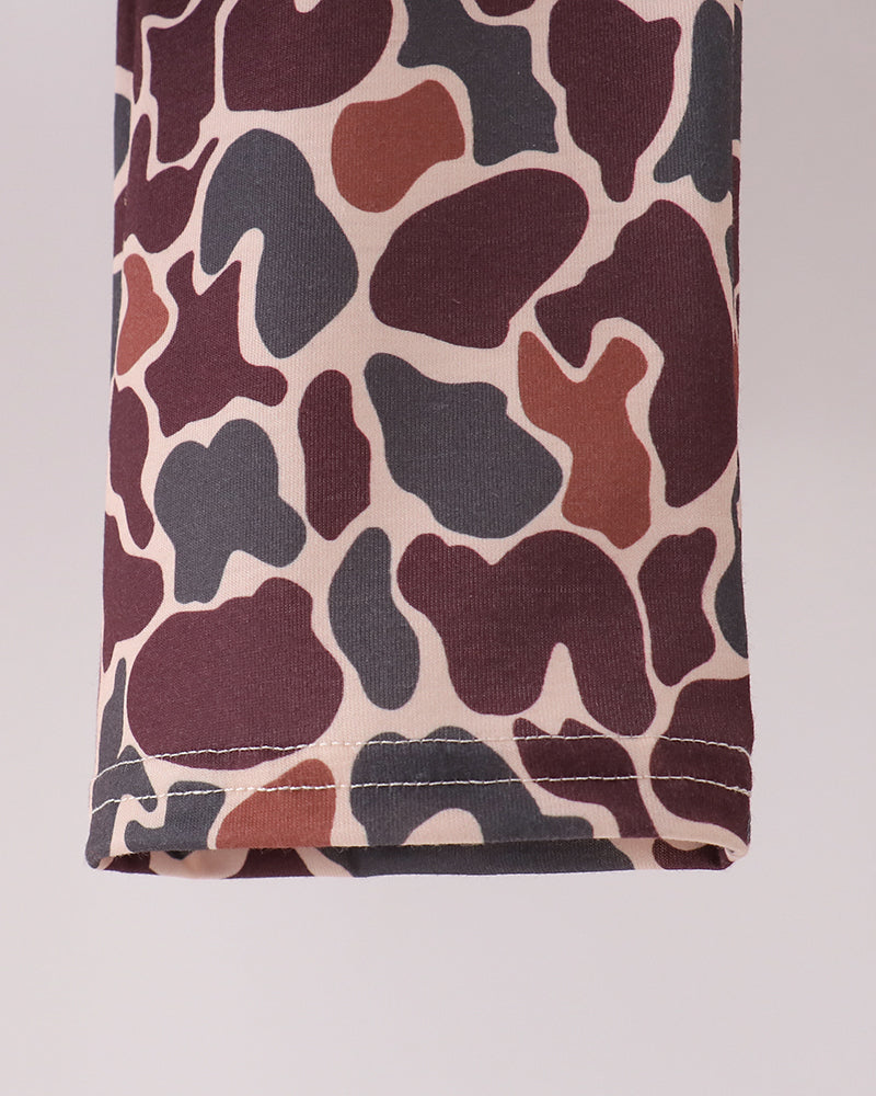 Camouflage pants hem with stitched cuff and all-over camo pattern.