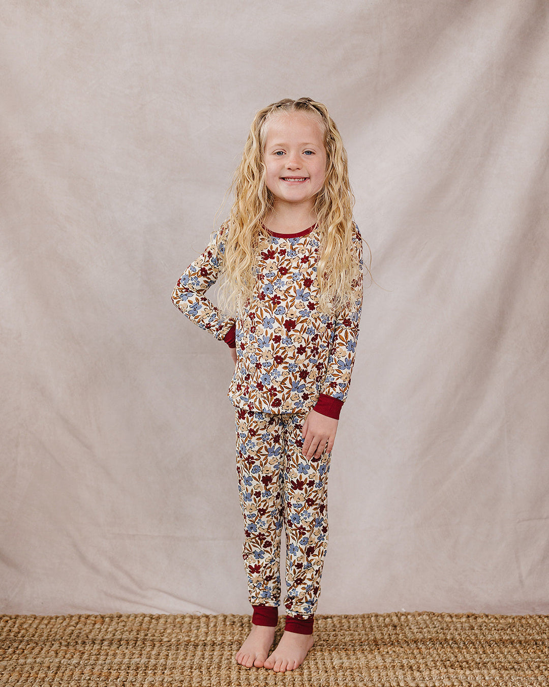Kids floral long-sleeve pajama set with burgundy cuffs and matching pants