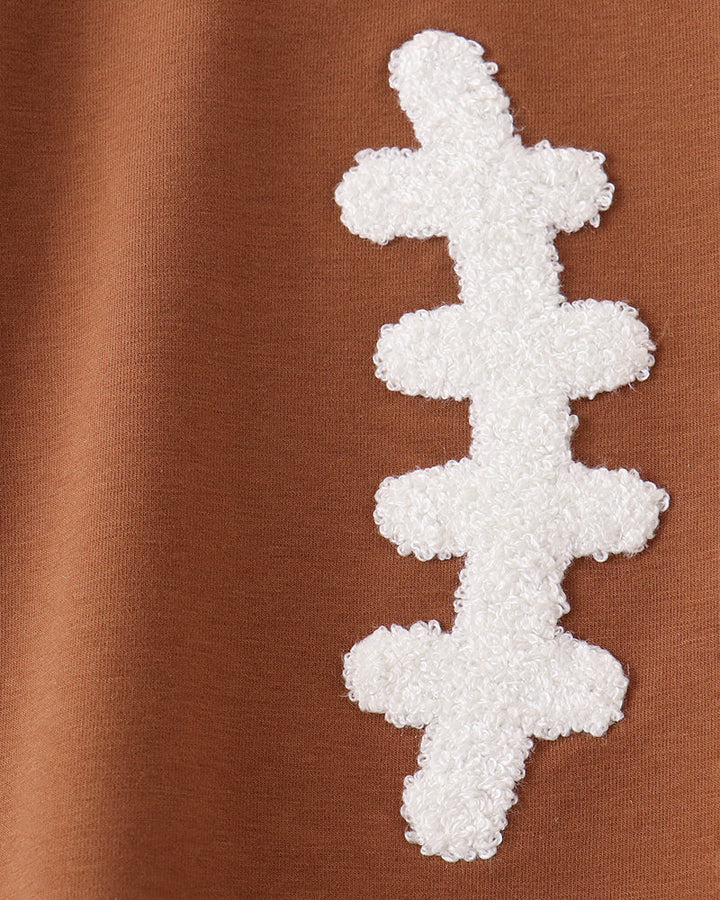 Brown long-sleeve top with white French-knot football applique detail on front.