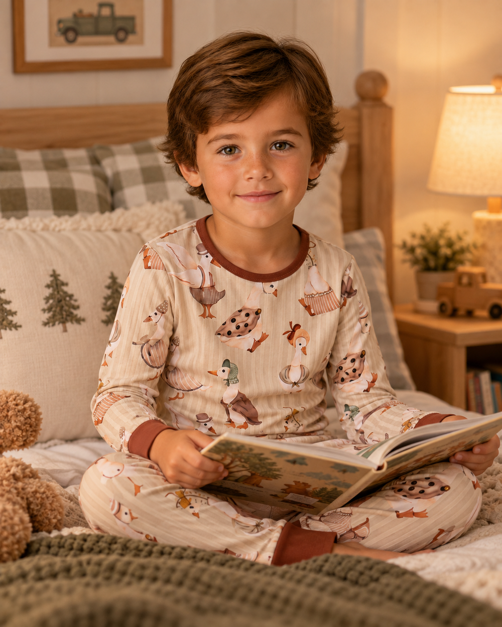 Boy wearing cream long-sleeve pajama set with brown animal print