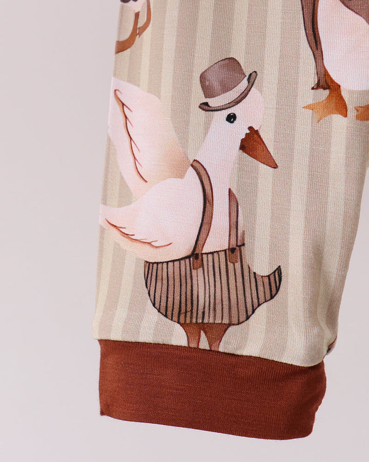 Cream pajama top with long sleeves, brown cuff hem, and animal print