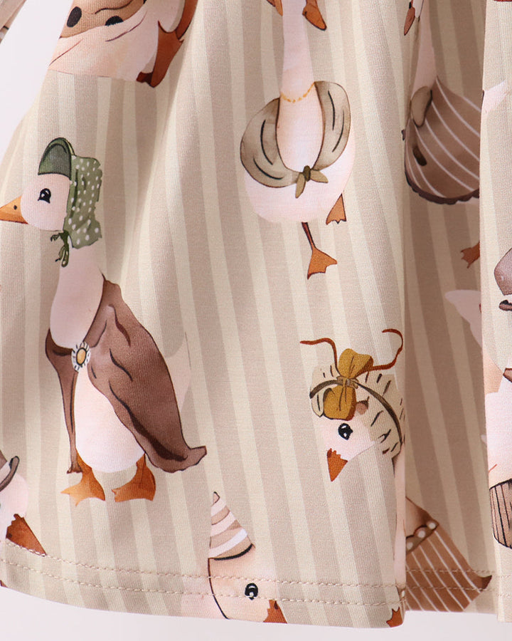 Cream animal-print long-sleeve tunic panel with gathered waist and illustrated birds