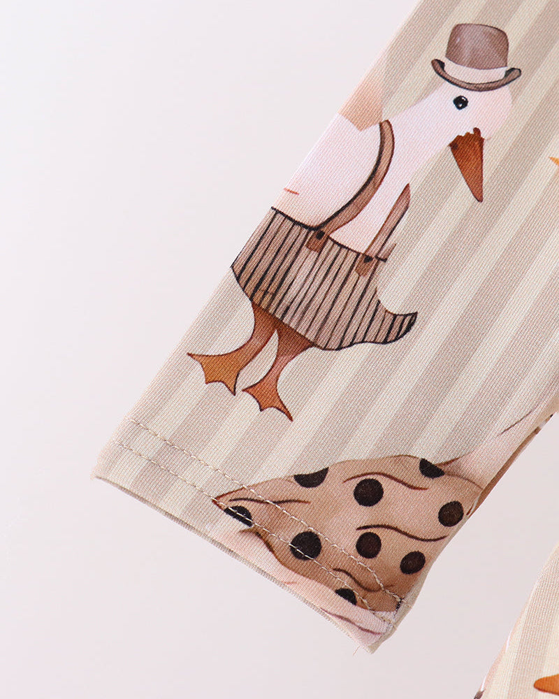 Cream animal-print sleeve cuff with stitched edge and brown-striped bird artwork