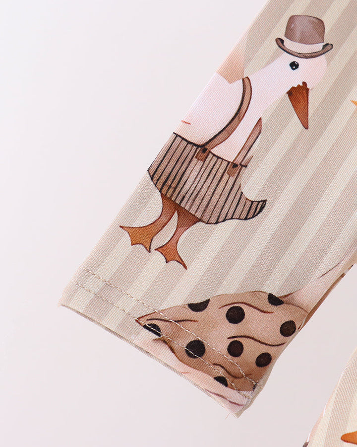 Cream animal-print sleeve cuff with stitched edge and brown-striped bird artwork