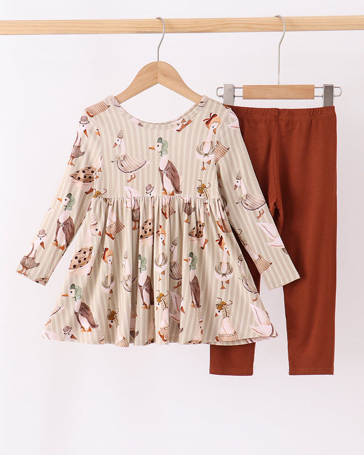 Animal-print long-sleeve tunic and rust-brown leggings set on hangers